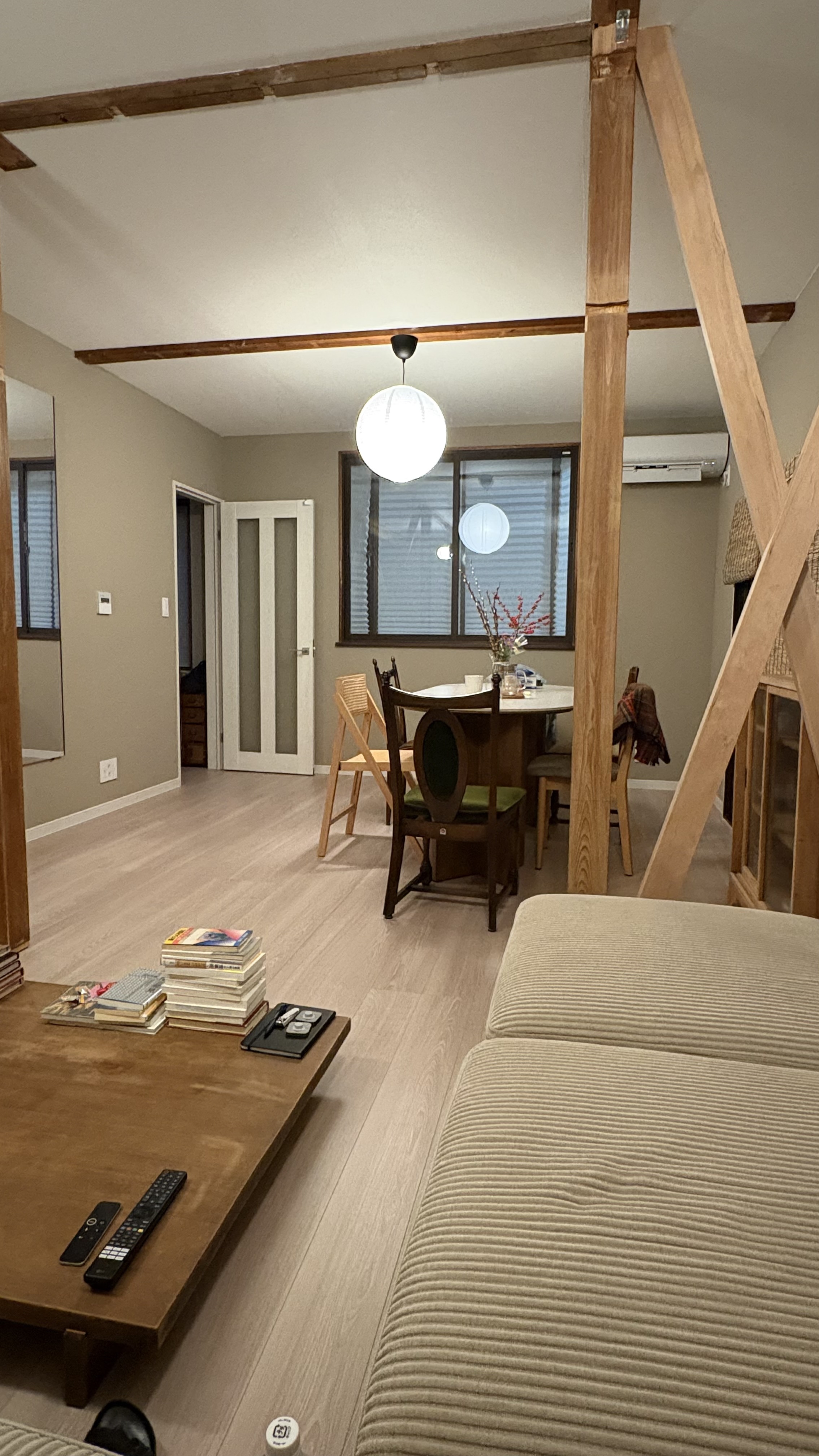Living room with exposed wooden beams and paper lantern lighting